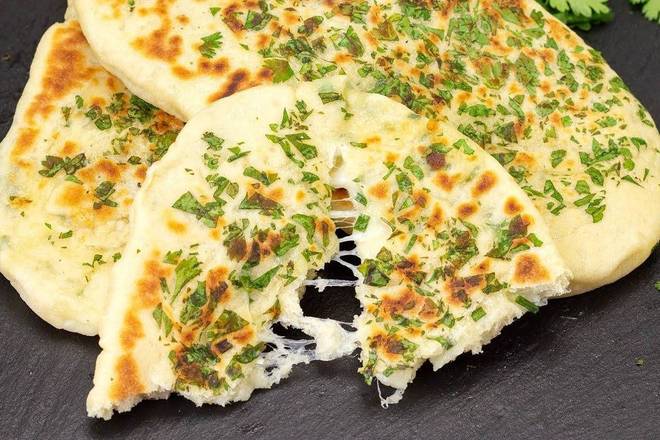 Order Garlic Cheese Naan food online from Hot Masala Bistro store, Camp Hill on bringmethat.com