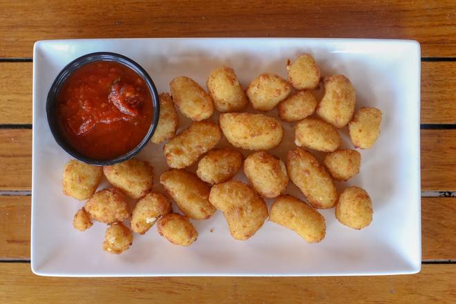Order Breaded Wisconsin Cheese Curds  food online from Tommy's Tavern + Tap store, Staten Island on bringmethat.com