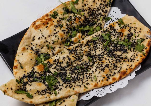 Order Kalonji Naan food online from Nirvana store, New Orleans on bringmethat.com