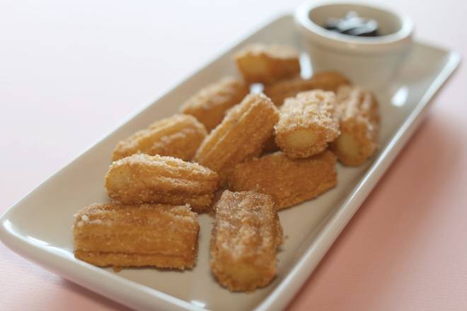 Order Dozen Churro Bites with Chocolate Sauce food online from Savage Burrito store, Brookfield on bringmethat.com