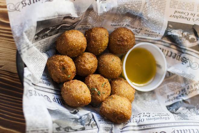 Order Hush Puppies food online from Hook & Reel Cajun Seafood store, lubbock on bringmethat.com
