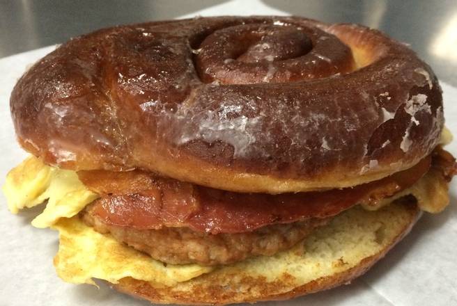Order Cinnamon Roll Donut Sandwich: Bacon, Egg, Sausage, & Cheese food online from Donut Tacos Palace store, Austin on bringmethat.com