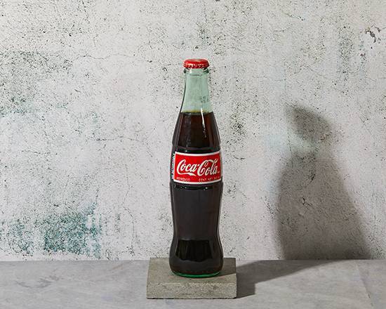 Order Coke (bottle) food online from Grilled & Cheesy store, New Smyrna Beach on bringmethat.com