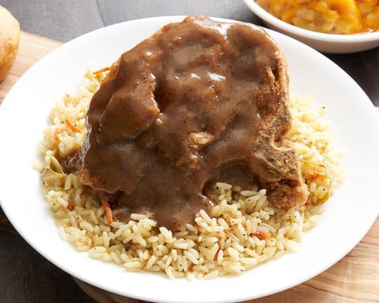 Order Smothered Pork Chops W/ Brown Gravy Over Sassy Rice food online from This Is It! store, Decatur on bringmethat.com