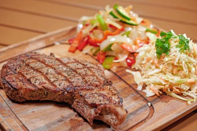 Order Rib Eye Steak (14oz) food online from Holy Schnitzel store, Aventura on bringmethat.com