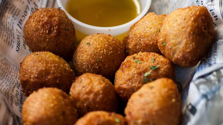 Order Hush Puppies food online from Hook & Reel Cajun Seafood store, Killeen on bringmethat.com