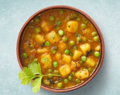 Order Simple Potato & Pea Curry food online from Veggie Mania store, Charlotte on bringmethat.com