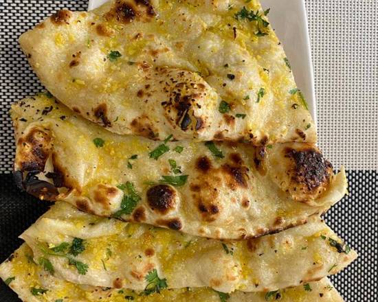 Order Garlic Naan food online from Passage to India store, Harrisburg on bringmethat.com